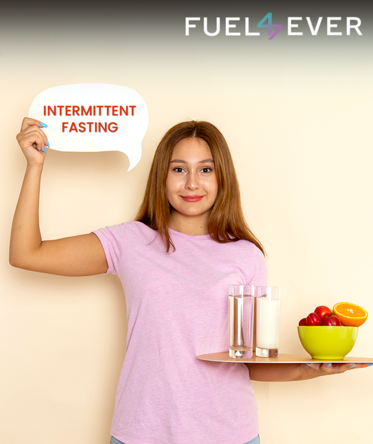 Girl holding board of intermittent fasting in one hand and in the other hand girl holding the foods you can eat while intermittent fasting