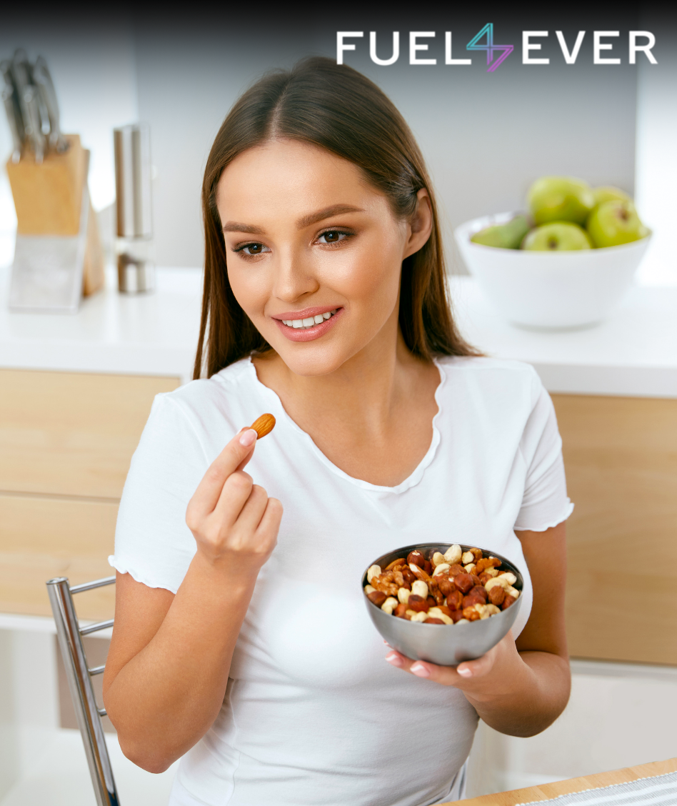 Girl holding bowl in her hand full of nuts and eating them